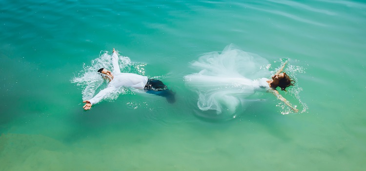 bride and groom in ocean