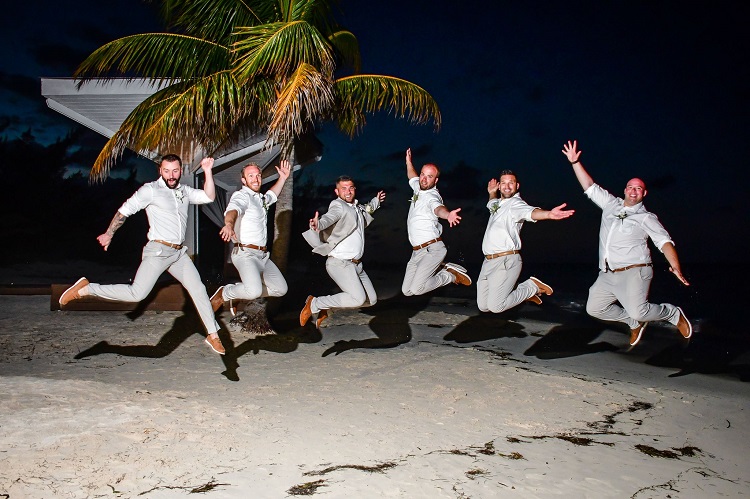 groomsmen jumping on beach