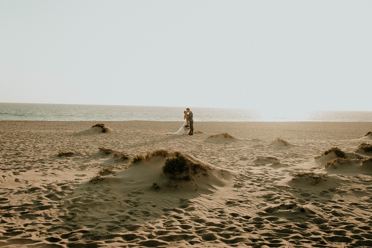 wedding couple walking on beach