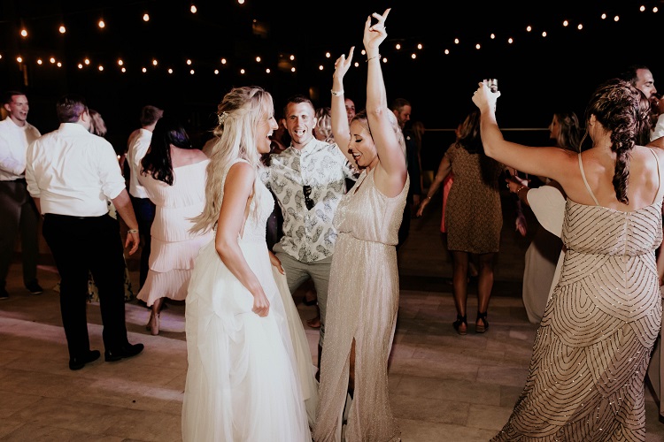 bride and bridesmaid dancing at reception