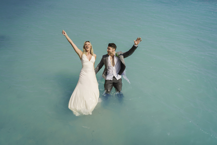 wedding couple jumping in Caribbean Sea