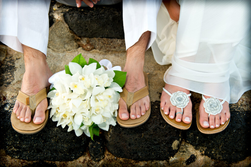 Close,Up,Of,A,Bride,And,Groom's,Feet,And,Bouquet.