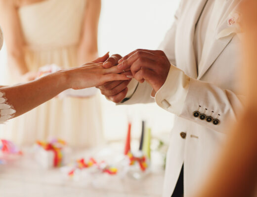 Beautiful,Gorgeous,Blonde,Bride,With,Orchids,And,Stylish,Groom,Putting