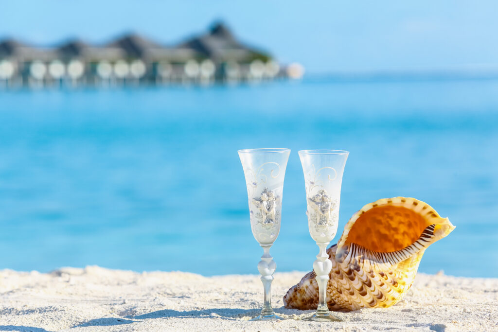 Two,Wedding,Glasses,Near,By,Beautiful,Seashell,On,The,Beach